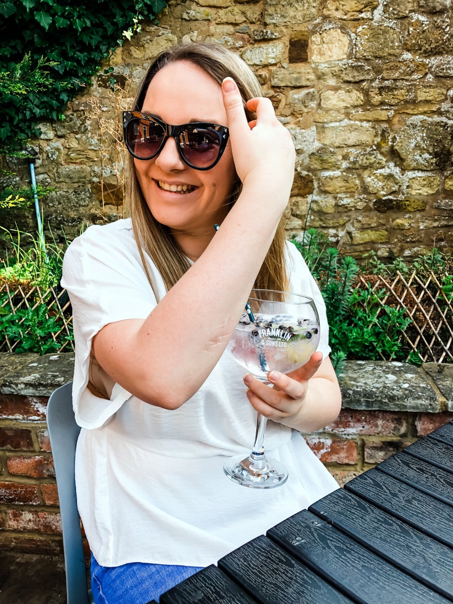 Nicole Navigates drinking gin at a pub garden in Northamptonshire